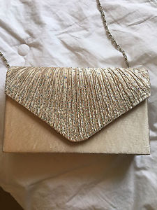 Never been used beige clutch.