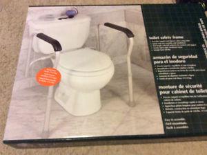 Raised toilet seat and safety rails