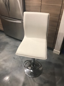 2 white, armless bar stools