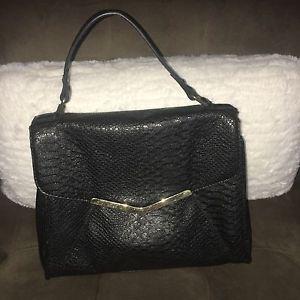 Black cosmopolitan purse with gold trim