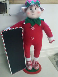 Christmas Elf holding sign