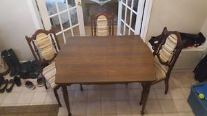 Dining table and 3 upholstered wooden chairs