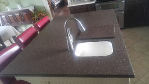 Solid surface, corian island countertop with sink.