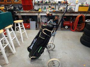 Old set of clubs and bag with cart.