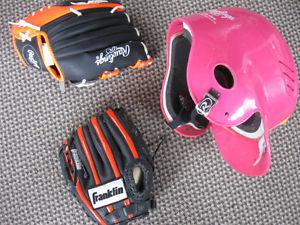Two child,s baseball gloves and a child's baseball helmet