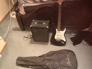 Black and white electric with amp and whammy bar