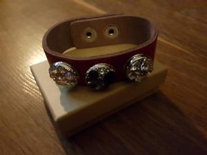 Leather bracelet with dog paw charms attached