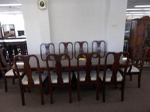 Beautiful dining table and ten matching chairs. $.
