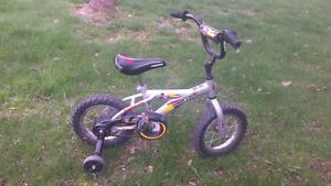 Boys small pedal bike comes with training wheels. Gently