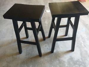 2 dark wood stools