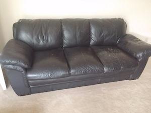 Black Leatherette three seater couch.