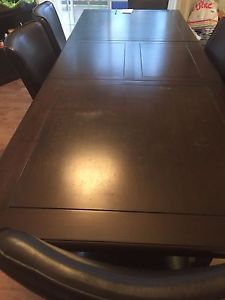 Large wooden table includes chairs