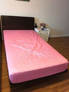 pink mattress with wooden frame
