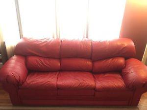 Red leather couch and white leather chair.
