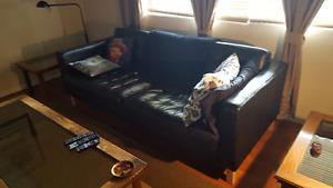 Black solid leather couch.. leather back