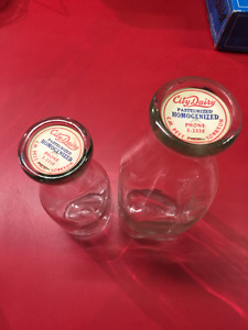 2 vintage milk bottles with caps