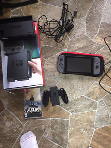 Nintendo Switch with Zelda, car charger, case.