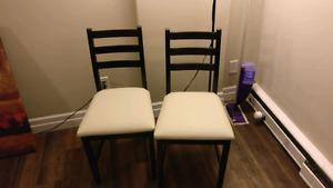Two Ikea chairs (one chair has a small hole in wood)