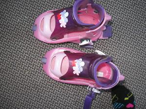 Two pair of adjustable girls roller blades