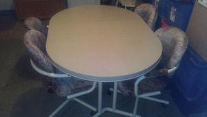 Kitchen table with 3/4 wheeled chairs