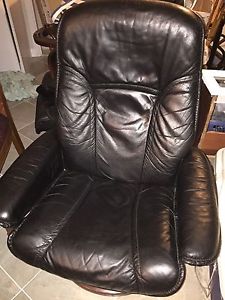 Two leather reclining chairs with two foot stools