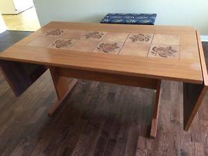 Teak table with ceramic tile inserts and 2 leafs. 2 teak