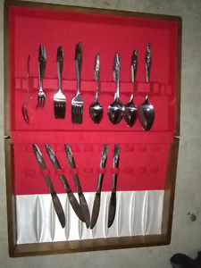 a set of spoons and forks. nice wooden box