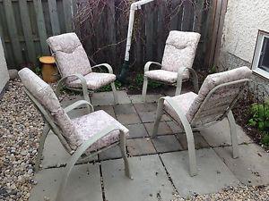 4 patio chairs with cushions.