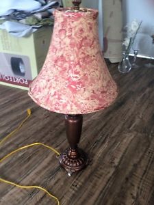 Small lamp with red damask pattern shade and candle holders