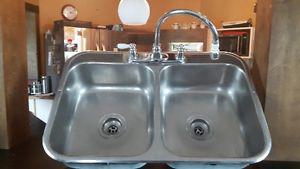 Stainless steel sink with taps