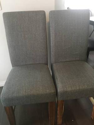 2 grey fabric and wood dining chairs