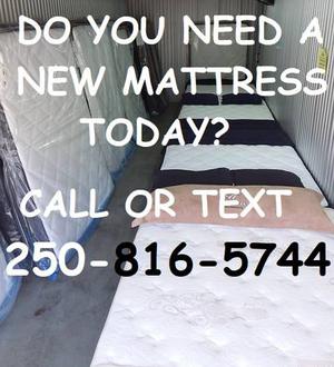 Large storage locker full of new mattresses for sale