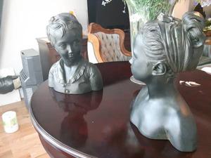decorator downsizing pair of male and female child busts.