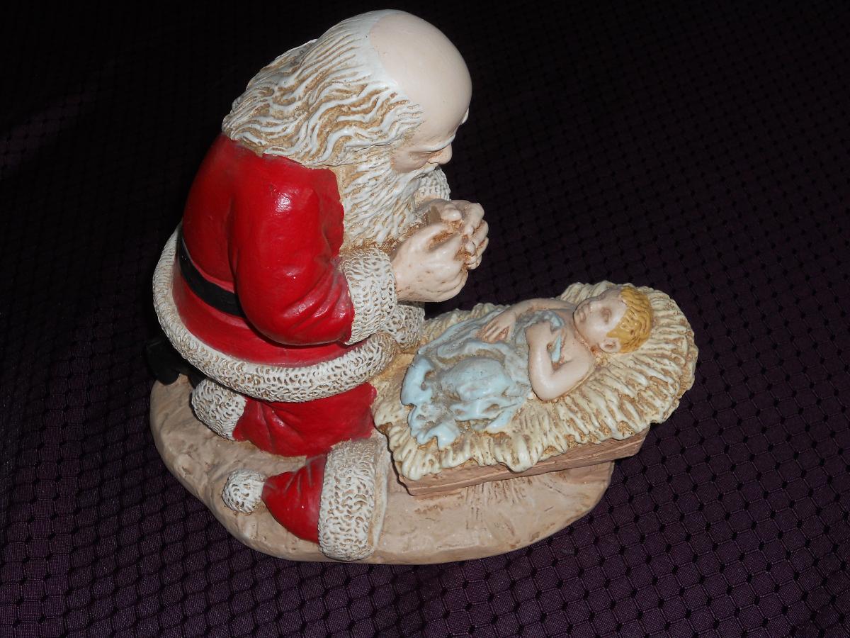 Kneeling Santa Praying over Baby Jesus