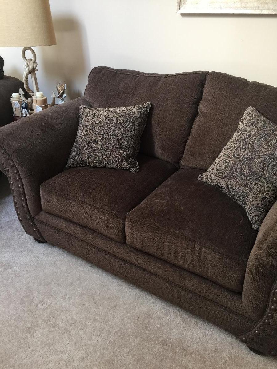 Brown loveseat and chair with ottoman