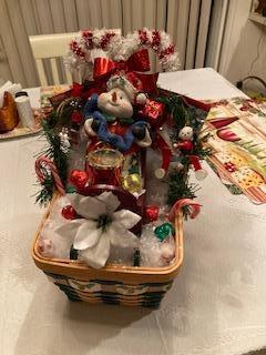 Christmas snowman in sleigh with goodies